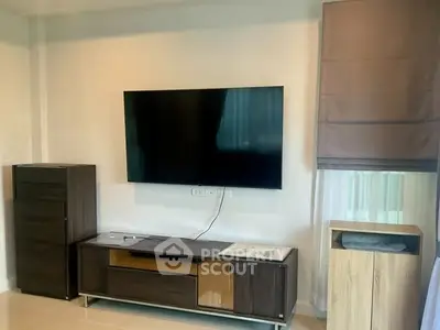 Modern living room with wall-mounted TV and stylish furniture