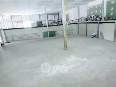 Spacious unfinished interior space ideal for customization in a versatile real estate property.