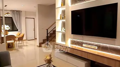 Modern living room with large TV and elegant dining area