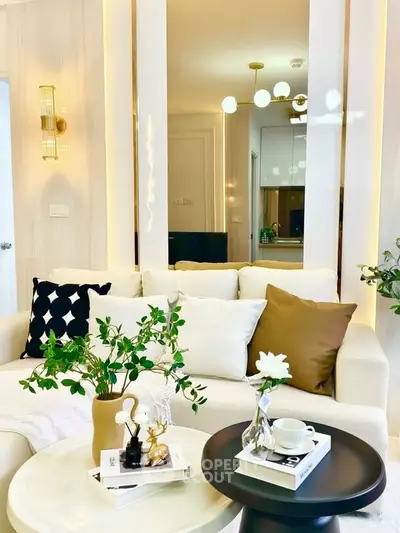 Elegant living room with modern decor, plush sofa, and stylish lighting, perfect for relaxation and entertaining.