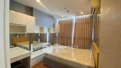 Modern bedroom with stylish furniture and large windows in a contemporary apartment.