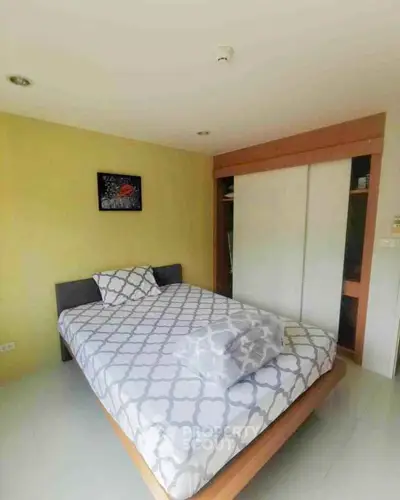 Cozy bedroom with modern decor and ample natural light