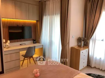 Elegant bedroom with modern decor, featuring a cozy workspace and natural light through large windows.