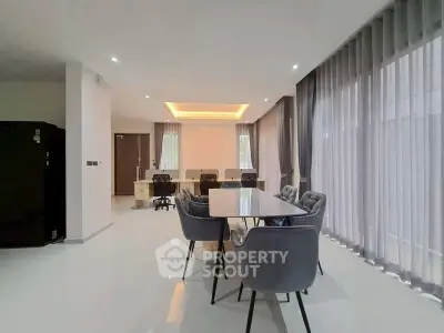 Spacious modern dining area with elegant lighting and large windows