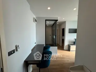 Modern study area with sleek desk and chairs in a contemporary apartment