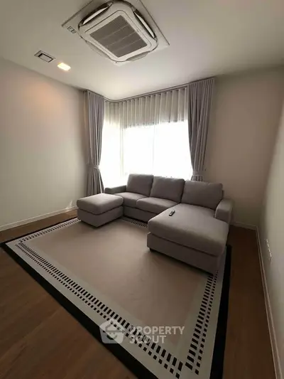 Modern living room with cozy sectional sofa and elegant curtains