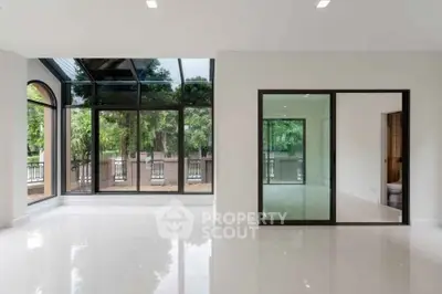 Spacious modern living room with large windows and garden view
