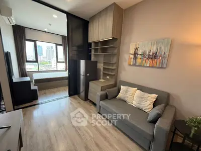 Modern studio apartment with open layout, featuring cozy living area and bedroom with city view.
