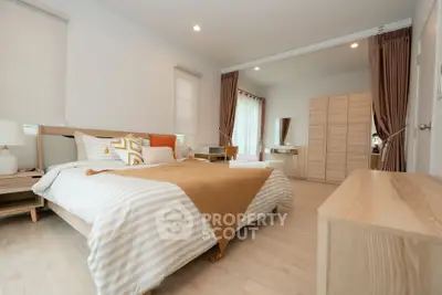 Spacious modern bedroom with elegant decor and natural light
