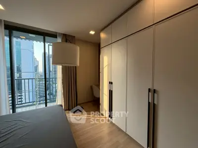 Modern bedroom with large wardrobe and city view balcony