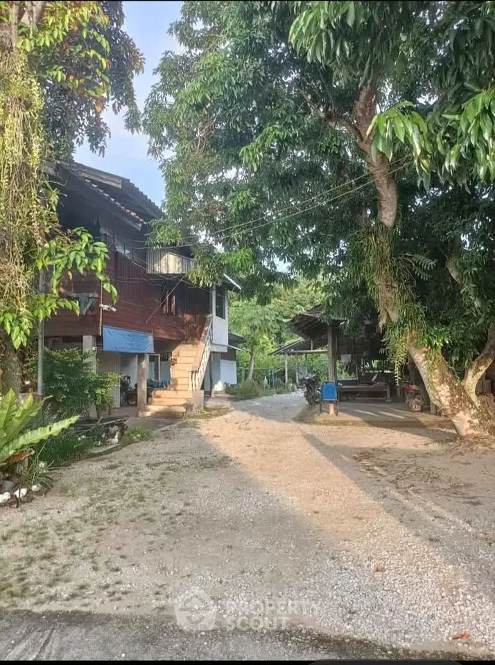 Charming rustic home with lush greenery and spacious outdoor area, perfect for nature lovers.