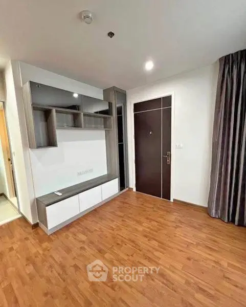 Modern apartment interior with wooden flooring and stylish storage unit