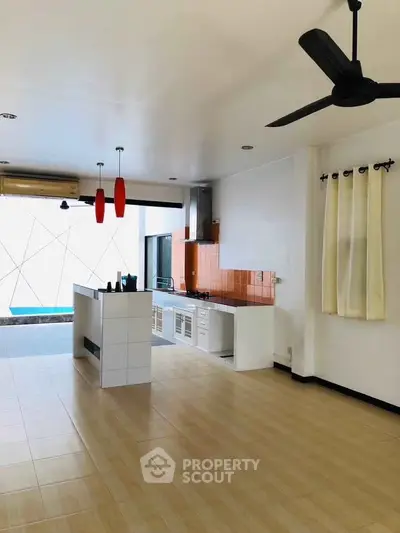 Spacious modern kitchen with open layout and stylish ceiling fan