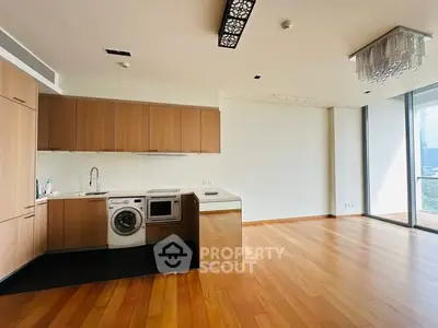 Spacious modern kitchen with wooden flooring and built-in appliances