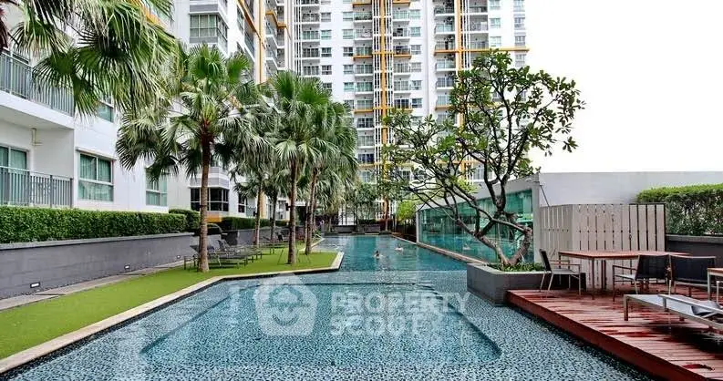 Luxurious condominium with stunning pool and lush greenery, perfect for relaxation and modern living.