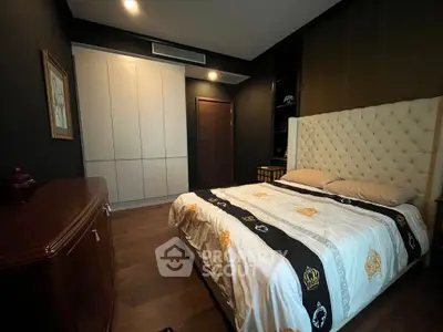 Luxurious bedroom with elegant decor and plush bedding in a modern apartment.