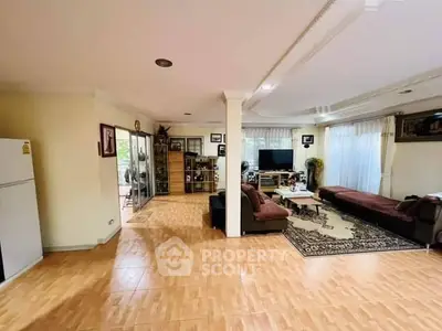 Spacious living room with elegant decor and ample natural light, perfect for family gatherings.