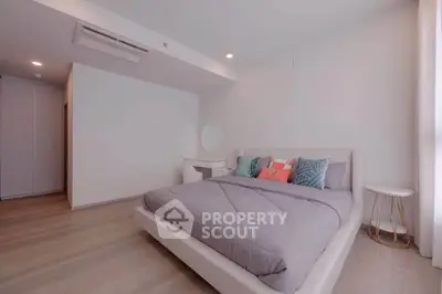 Spacious modern bedroom with stylish decor and natural light