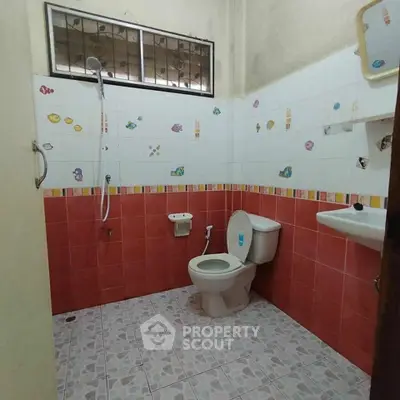 Charming bathroom with colorful tiles and modern fixtures, perfect for a cozy home.