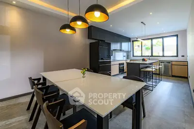 Modern kitchen with sleek design, featuring an open layout and stylish lighting.