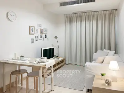 Modern minimalist living room with cozy white sofa, stylish decor, and natural light.