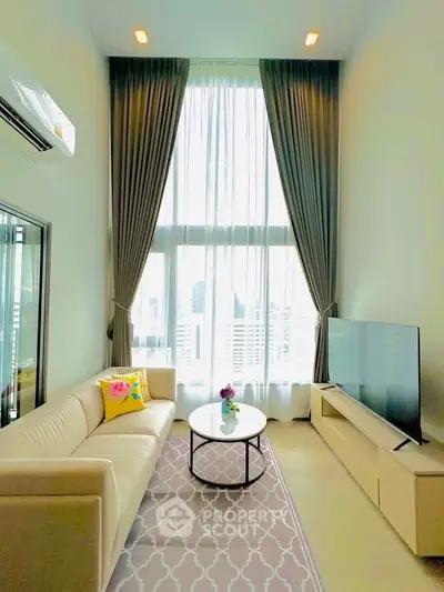 Luxurious high-ceiling living room with large windows and modern decor in a city apartment.