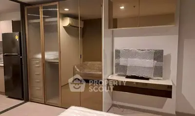 Modern apartment interior with sleek design, featuring a cozy bedroom and stylish living area.