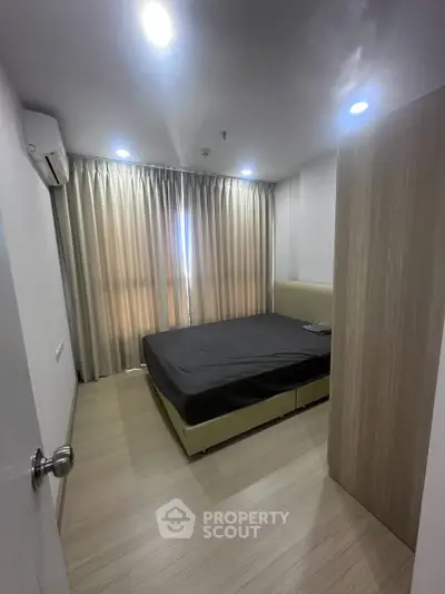 Modern bedroom with sleek design and natural light, featuring a comfortable bed and stylish curtains.