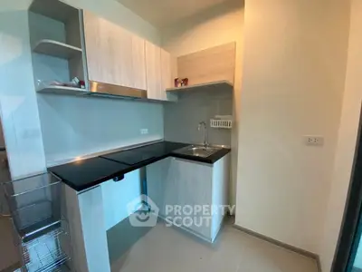 Modern compact kitchen with sleek cabinetry and built-in sink