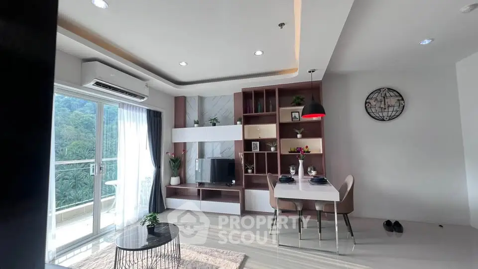 Modern living room with balcony and stylish decor in a high-rise apartment.