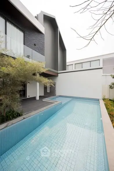 Modern luxury home with sleek pool and contemporary architecture.