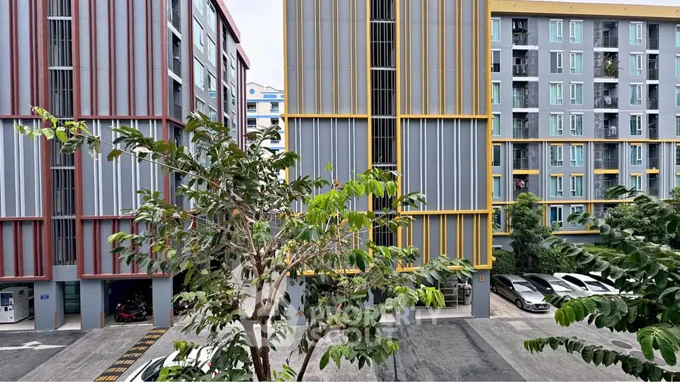 Modern apartment buildings with colorful facades and parking area