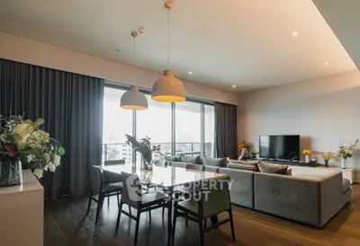 Spacious modern living room with large windows and elegant dining area.
