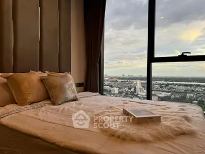 Luxurious bedroom with stunning city view from large window, featuring elegant decor and cozy bedding.