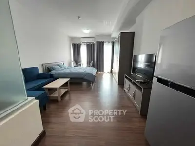 Spacious studio apartment with modern furnishings and natural light.