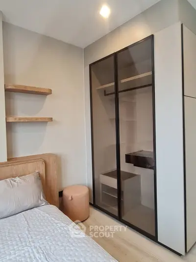 Modern bedroom with sleek wardrobe and cozy bed in stylish apartment