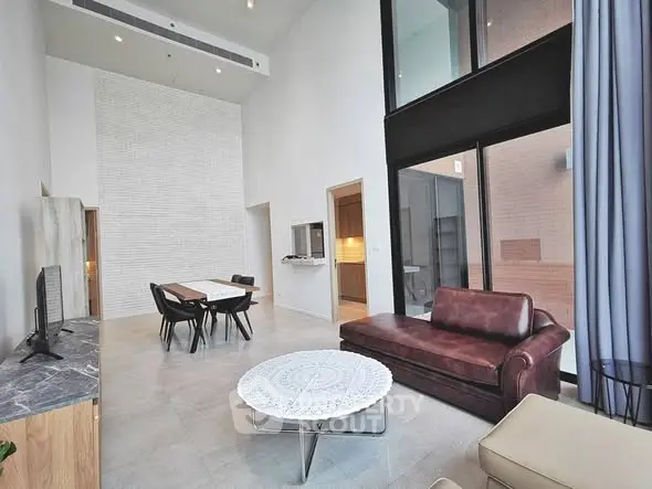 Spacious modern living room with high ceilings and stylish furniture