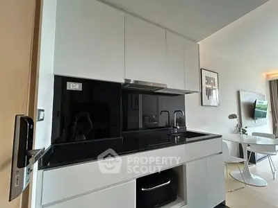 Modern kitchen with sleek black countertops and integrated appliances