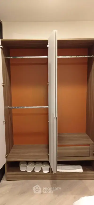 Spacious modern wardrobe with sleek design and ample storage space in a stylish interior.