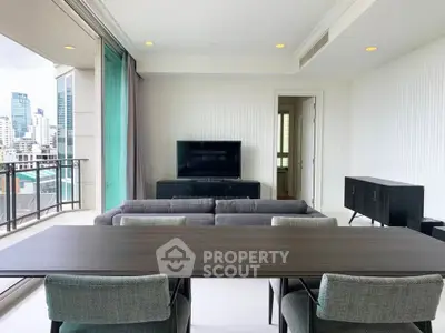 Spacious modern living room with city view and elegant furnishings.