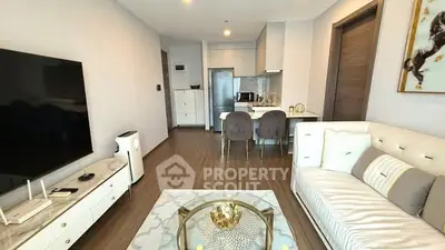 Modern living room with elegant decor, open kitchen layout, and stylish furniture in a contemporary apartment.
