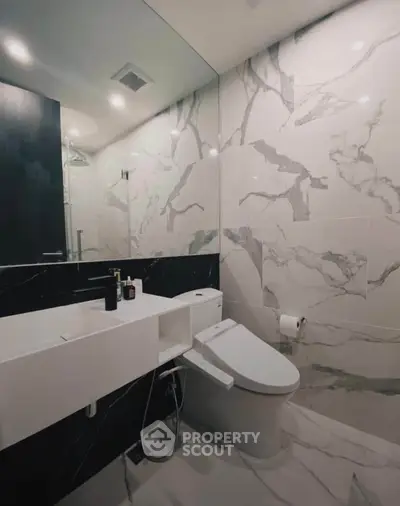 Luxurious modern bathroom with marble tiles and sleek fixtures