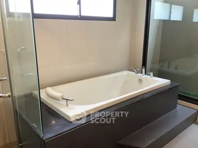 Luxurious bathroom with modern bathtub and glass shower enclosure