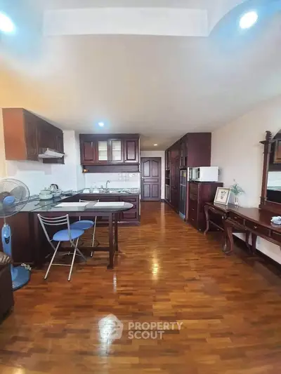 Spacious kitchen with wooden flooring and modern appliances