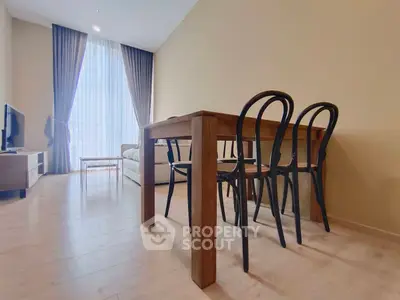 Spacious living room with elegant dining area and natural light