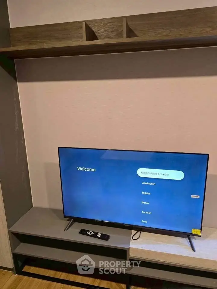 Modern living room with sleek TV setup and stylish shelving unit.