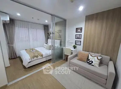 Modern bedroom with glass partition, cozy sofa, and stylish decor