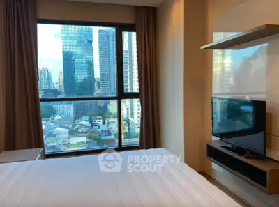 Modern bedroom with stunning city view from large window, featuring a sleek TV and minimalist decor.