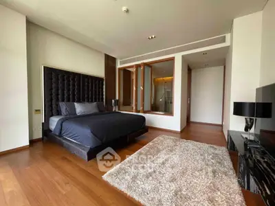 Luxurious bedroom with modern decor and plush furnishings in upscale apartment.