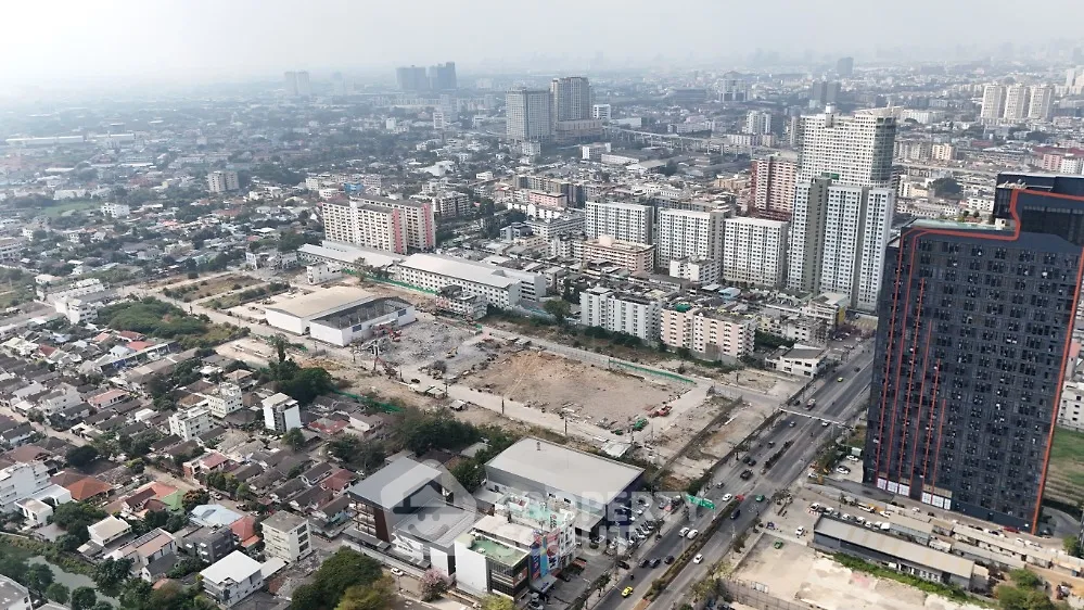 Aerial view of urban real estate development with high-rise buildings and construction site.